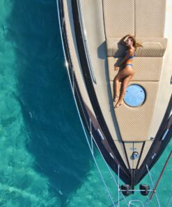 woman in black bikini lying on blue and white boat during daytime